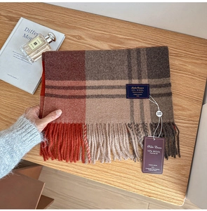 Detail of wool blend plaid scarf with tassels, 10% wool label and brand tags