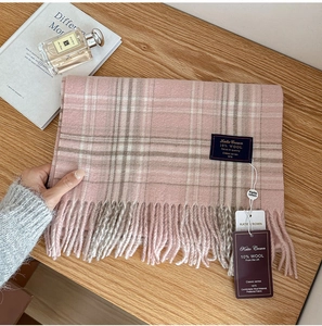 Detail of pink plaid scarf texture with 10 percent wool tag and Katie Crown brand label