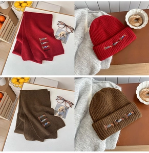 Detail of embroidered dachshund motifs on thick burgundy and brown knitted winter sets