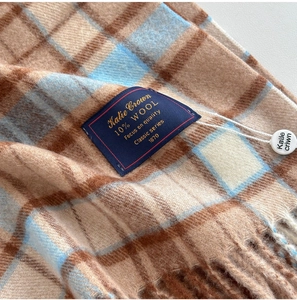 Detail of wool blend plaid scarf fabric texture and the Katie Crown brand label
