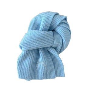 Light blue knitted wool blend scarf with ribbed texture and embroidered bow detail