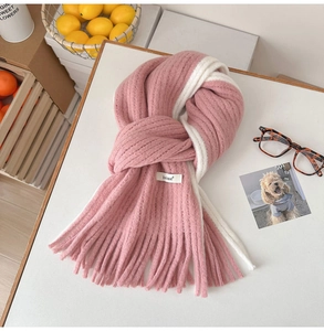 Vue détaillée d'une écharpe en mohair rose et blanc avec texture tricotée et franges
