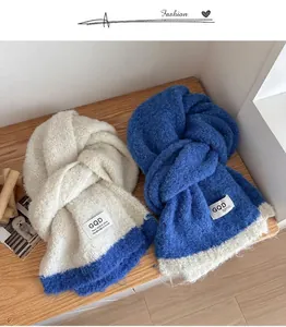 Detail of color-block knit scarves in beige and blue showing soft wool texture