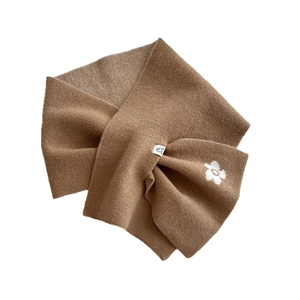 Knitted brown scarf for women featuring a white flower pattern and crossover design