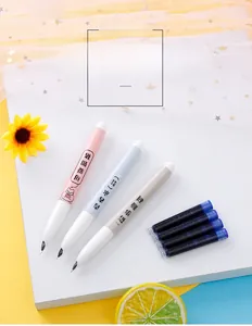 Three colorful fountain pens with four blue ink cartridges on a bright decorative desk