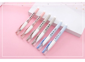 Set of six pastel pens with cute cartoon pig patterns on a pink geometric display stand