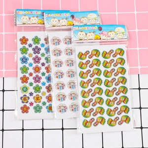Detail view of colorful merit stickers for kids featuring thumb up and award patterns