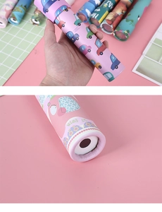 Close-up of colorful cartoon patterns and lens structure of a rotating toy kaleidoscope