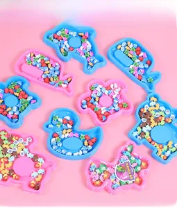 Detail of colorful animal-shaped miniature erasers set in cute blue and pink trays