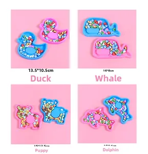 Detail view of colorful animal-shaped trays including duck and whale for kids' DIY crafts