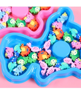 Close-up of colorful dinosaur cartoon erasers in blue and pink display trays for kids