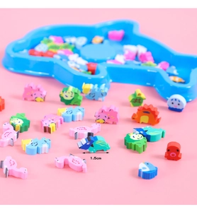 Close-up of 1.5cm mini animal erasers in various shapes with a dolphin-shaped tray