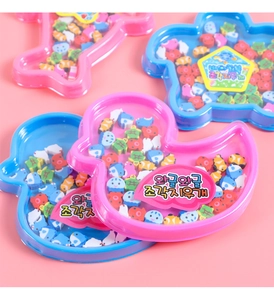 Macro detail of cute animal shaped mini erasers in colorful fish and turtle patterns
