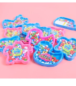 Detail view of mini animal-shaped erasers in cute duck and whale plastic containers