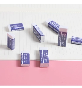 Detail showing soft purple 2B plastic erasers on a pink and striped notebook background