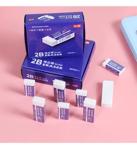 Bulk display of white 2B erasers in a 30-piece box set on a soft pink desk