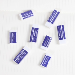 Blue and white 2B soft erasers for students on a white lined notebook background