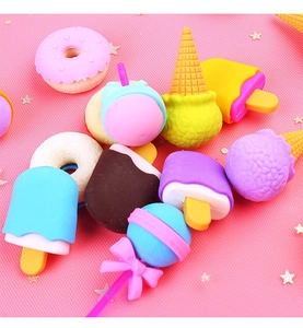 Close-up of cute dessert shaped erasers including donuts and ice cream on pink glitter mesh