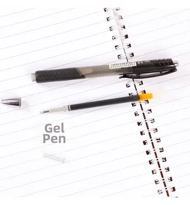 Detailed view of disassembled black gel pen components on a spiral notebook background