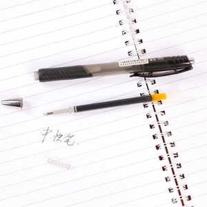 0.5mm black retractable gel pen shown disassembled on a notebook for school and office