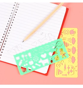 Close-up of plastic drawing templates for kids showing diverse shapes on pink background
