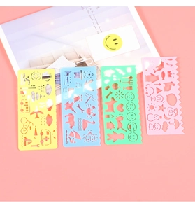 Close-up of colorful plastic geometric drawing templates with various hollow patterns for kids