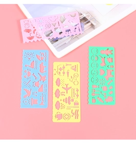 Detailed view of four colorful plastic drawing stencils with various cartoon cutouts
