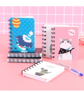 Detail of A7 mini spiral notebooks with various cute cartoon covers on pink background