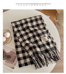 Close-up of multicolor plaid cashmere-feel scarf with long tassels and logo label detail