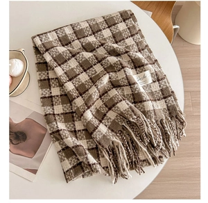 Detailed view of checkered cashmere-feel scarf with fringes and woven brand label