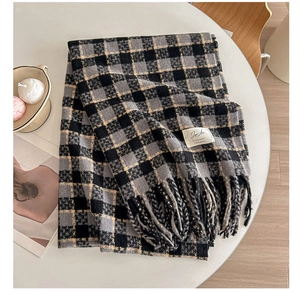 Detail showing high-quality plaid scarf fabric texture with classic fringe and label