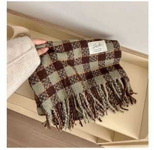 Close-up of retro plaid scarf with deep brown and green checks and fringe tassels