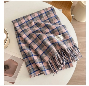Detail of pink and blue plaid cashmere-feel scarf with fringe and quality label