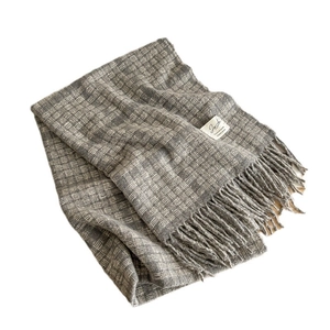 Plaid wool scarf in gray pattern with long tassels and a woven logo label for winter