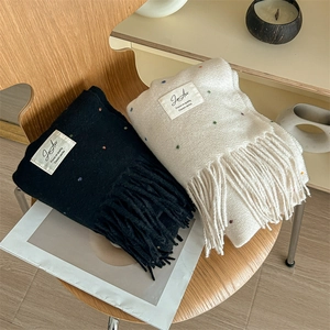 Soft knit scarf with colorful dots and long tassels in black and cream white colors