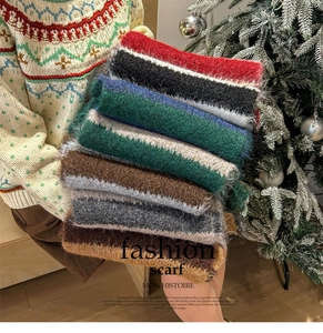 Detail shot of multi-color striped knitted scarves in red, blue, green and khaki wool