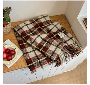 Close-up of thick checkered knit scarf with long tassels and soft fringe texture