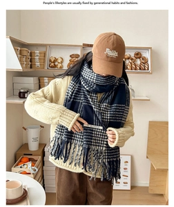 Close-up of classic navy blue houndstooth scarf with tassels and autumn outfit details