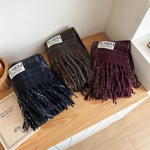 Retro plaid scarves with tassels in navy, coffee, and wine red on a wooden table