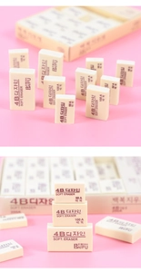 Macro shot of assorted 4B soft erasers in 50A and 200A sizes with pink background