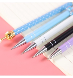 Detail of metal mechanical pencils with elegant gold crown and pearl decorative tips