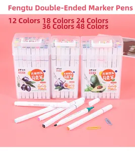 Detail view of dual-tip markers in portable storage boxes on pink background
