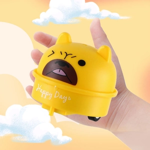 Close-up of small cartoon dog pull back toy car held in hand for size comparison