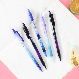 Set of five galaxy-themed mechanical pencils with 0.5/0.7mm lead on a white notebook
