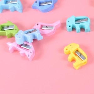 Cute animal pencil sharpeners in elephant and bird shapes on a pink background