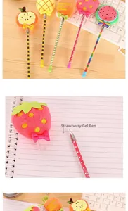 Macro view of plush fruit gel pens featuring cute strawberry and carrot designs on wood desk