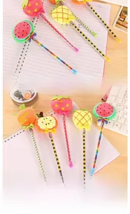 Detailed view of plush fruit toppers and colorful patterned barrels on novelty pens