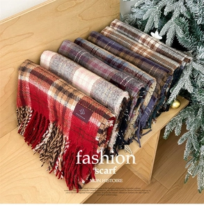 Close-up of soft plaid scarves with fringe details in classic Scottish checkered patterns
