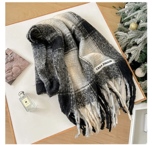 Detail of soft mohair plaid scarf with tassels and brand label on a winter gift set