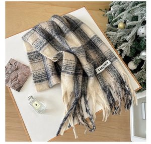 Close-up of winter mohair plaid scarf with long tassels and premium soft texture